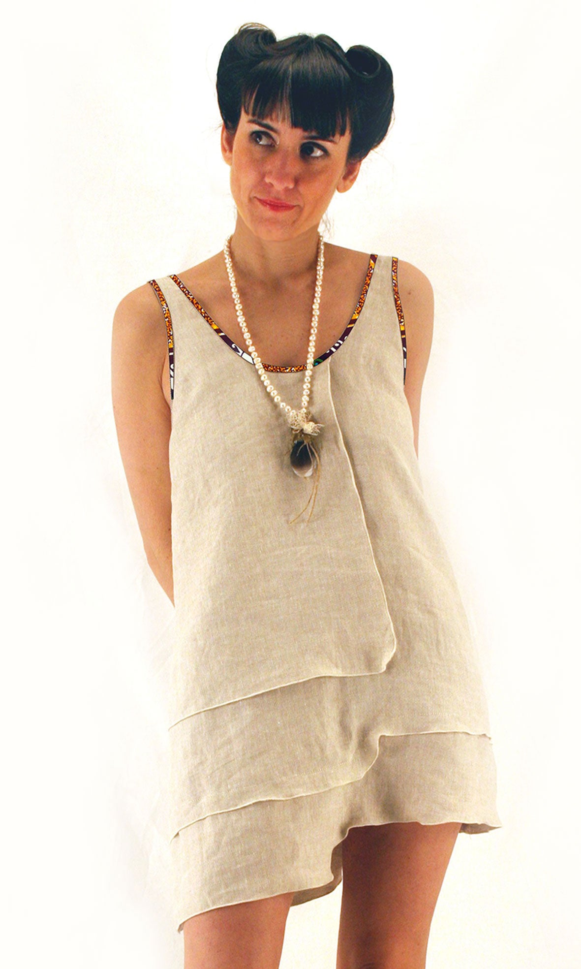 Linen dress with afro profiles with deep neckline at the back and asymmetric hem